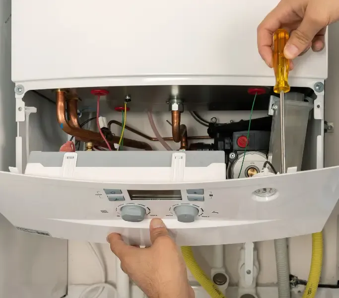 A Gas Safe registered engineer servicing a modern combi boiler in a London home